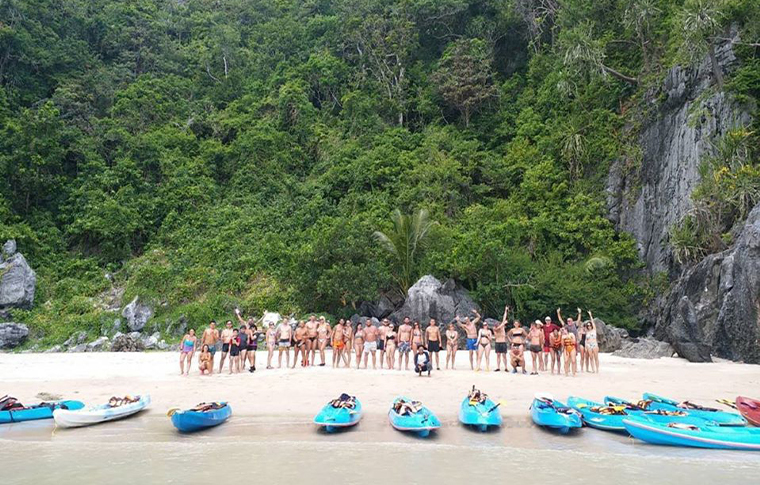 Group picture of a group of kayakers on the beach