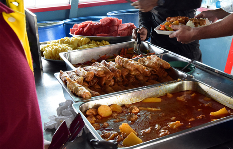 Picture of a food buffet with lots of colourful fruits and veggies